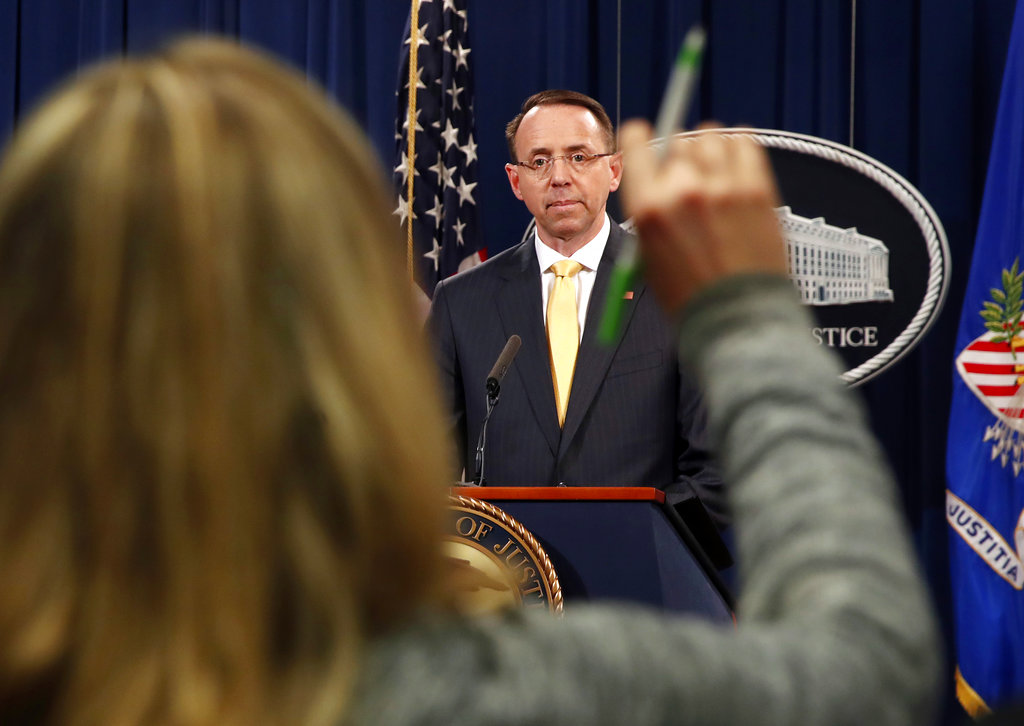 A reporter raises her hands to ask a question of Deputy Attorney General Rod Rosenstein, after he announced that the office of special counsel Robert Mueller says a grand jury has charged 13 Russian nationals and several Russian entities, Friday, Feb. 16, 2018, in Washington. The defendants are accused of violating U.S. criminal laws to interfere with American elections and the political process.