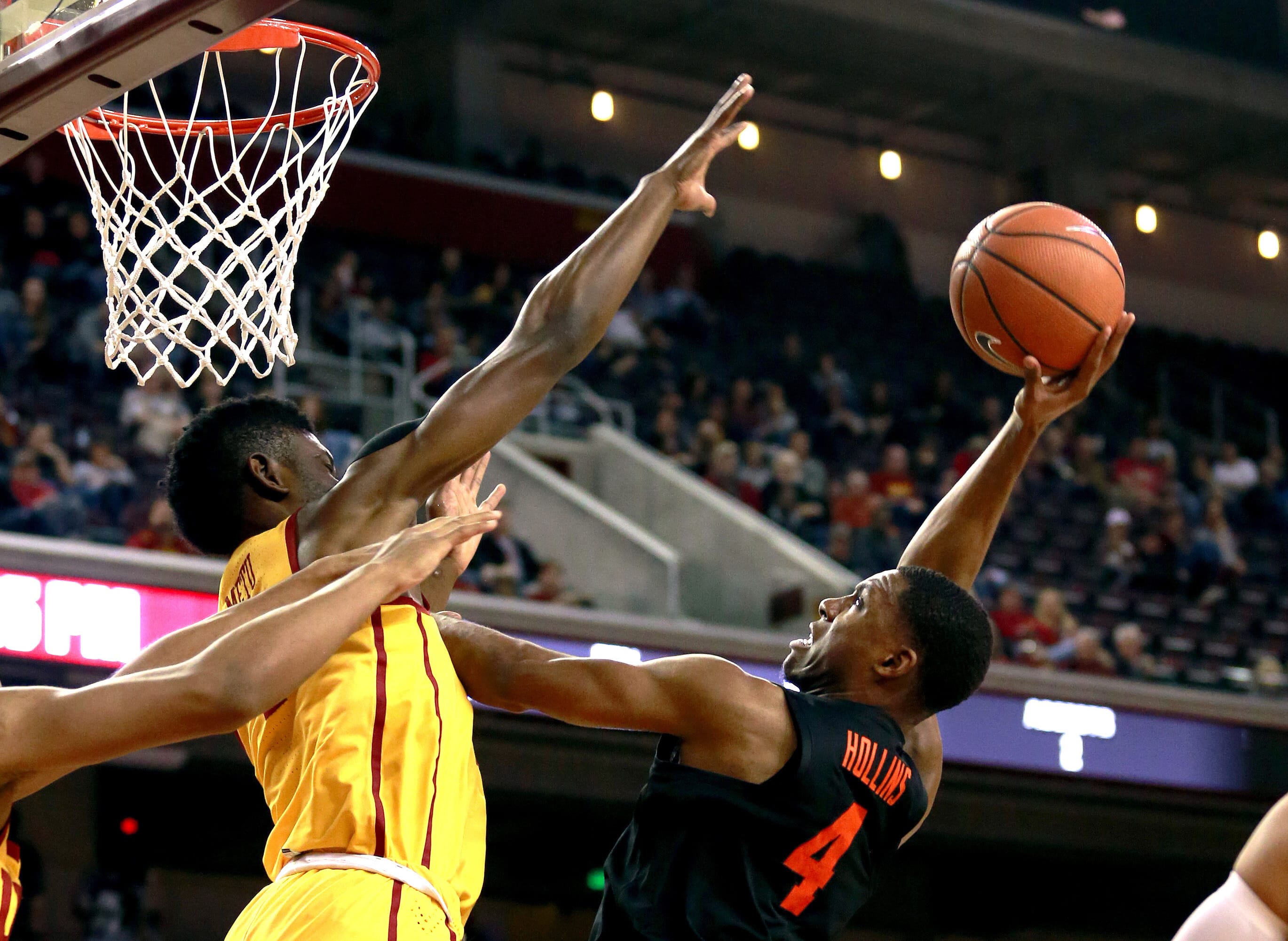 Oregon State forward Alfred Hollins, right, shoots under pressure from Southern California forward Chimezie Metu during the first half of an NCAA college basketball game Saturday, Feb. 17, 2018, in Los Angeles. (AP Photo/Ringo H.W.
