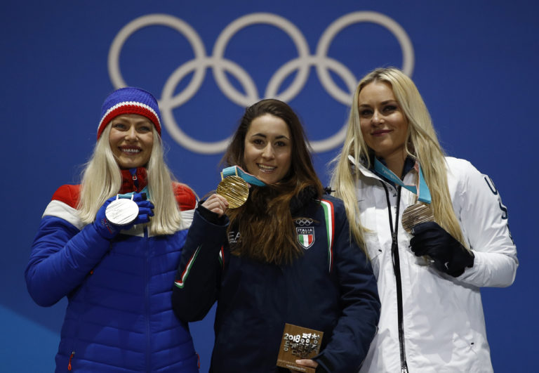 Medalists in the women's downhill, from left, Norway's Ragnhild Mowinckel, silver, Italy's Sofia Goggia, gold, and United States' Lindsey Vonn, bronze, pose during their medals ceremony at the 2018 Winter Olympics in Pyeongchang, South Korea, Wednesday, Feb. 21, 2018.