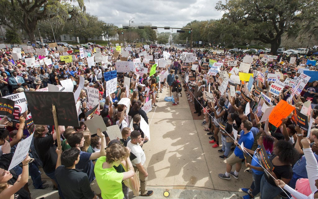 Students gather on the steps of the old Florida Capitol protesting gun violence in Tallahassee, Fla., Wednesday, Feb. 21, 2018.   Students at schools across Broward and Miami-Dade counties in South Florida planned short walkouts Wednesday, the one week anniversary of the deadly shooting at Marjory Stoneman Douglas High School.
