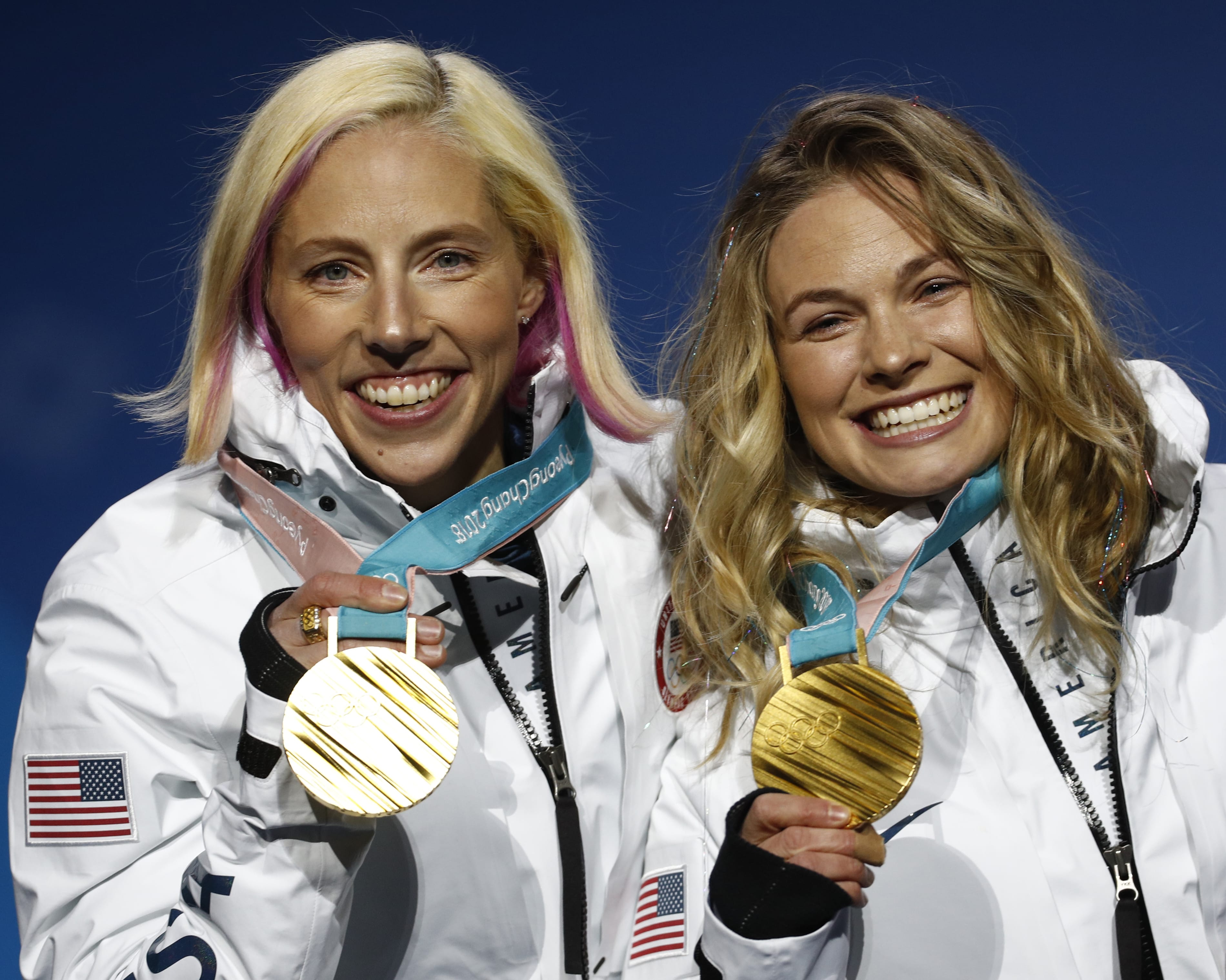 Gold medalists in the women's team sprint freestyle cross-country skiing Kikkan Randall and Jessica Diggins, of the United States, pose during the medals ceremony at the 2018 Winter Olympics in Pyeongchang, South Korea, Thursday, Feb. 22, 2018.