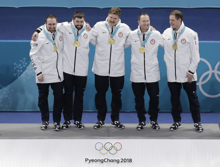 From left, United States' curling team Joe Polo, John Landsteiner Matt Hamilton, Tyler George and skip John Shuster smiles after receiving their gold medals after awarding ceremonies in their men's curling finals match against Sweden at the 2018 Winter Olympics in Gangneung, South Korea, Saturday, Feb. 24, 2018.