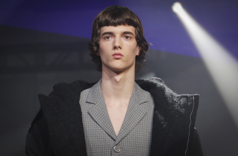Fashion from Raf Simons men’s collection is modeled during Fashion Week, Wednesday in New York. Models seldom smile on the runway becausee they are directed to stay in character.