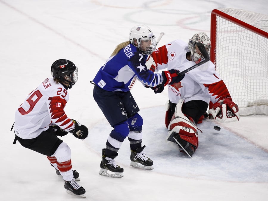 Monique Lamoureux-Morando (7) of the United States shoots the puck past goalie Shannon Szabados (1) of Canada for a goal during the third period of the women’s gold medal hockey game Thursday at the 2018 Winter Olympics in Gangneung, South Korea. Jae C.