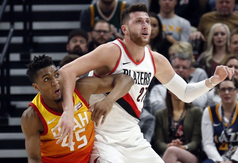 Utah Jazz guard Donovan Mitchell (45) guards Portland Trail Blazers center Jusuf Nurkic (27) during the first half of an NBA basketball game Friday, Feb. 23, 2018, in Salt Lake City.
