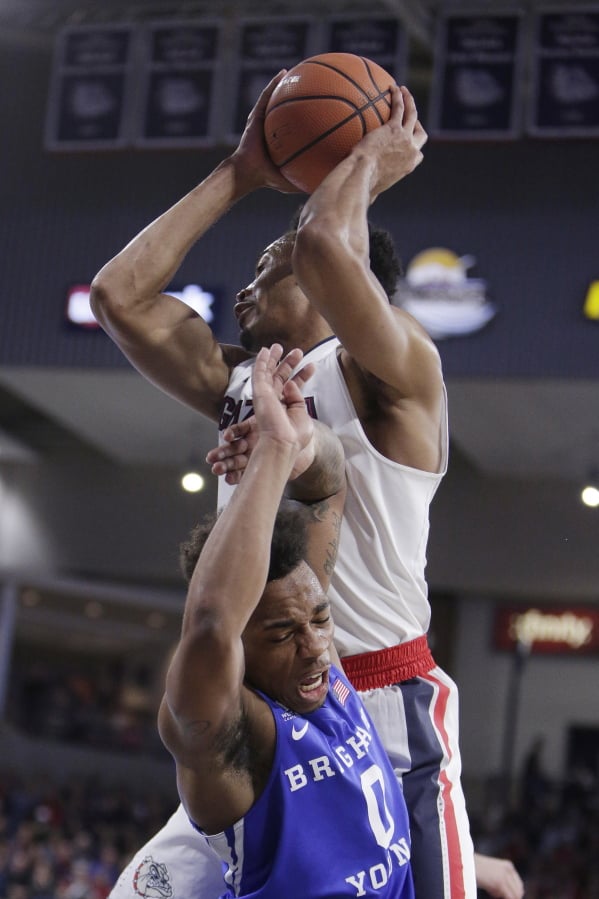 Gonzaga forward Johnathan Williams, top, grabs a rebound over BYU guard Jahshire Hardnett during the first half of an NCAA college basketball game in Spokane, Wash., Saturday, Feb. 3, 2018.