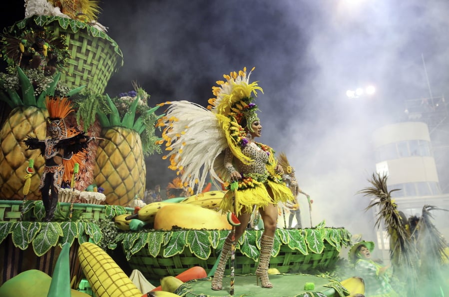 Dancers from the Rosas de Ouro samba school perform on a float during a carnival parade in Sao Paulo, Brazil, Saturday, Feb. 10, 2018.