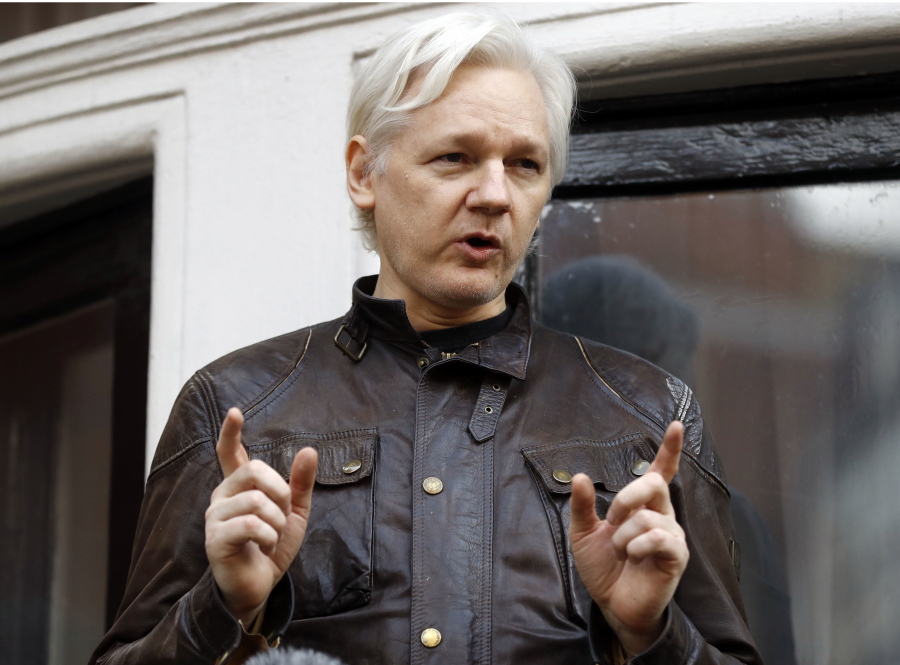WikiLeaks founder Julian Assange gestures May 19 to supporters outside the Ecuadorian embassy in London, where he has been in self imposed exile since 2012. A British judge on Tuesday, 20-18 is scheduled to quash or uphold an arrest warrant for WikiLeaks founder Julian Assange, who has spent more than five years inside Ecuador’s London embassy.