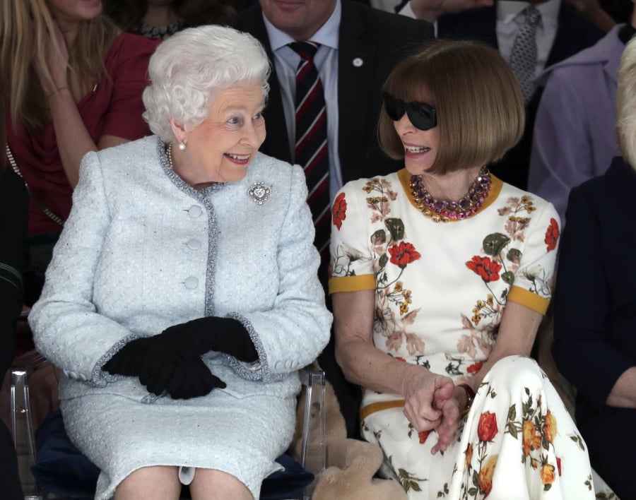 Britain’s Queen Elizabeth sits next to fashion editor Anna Wintour as they view Richard Quinn’s show before presenting him with the Queen Elizabeth II Award for British Design, as she visits London Fashion Week’s BFC Show Space in central London on Tuesday.