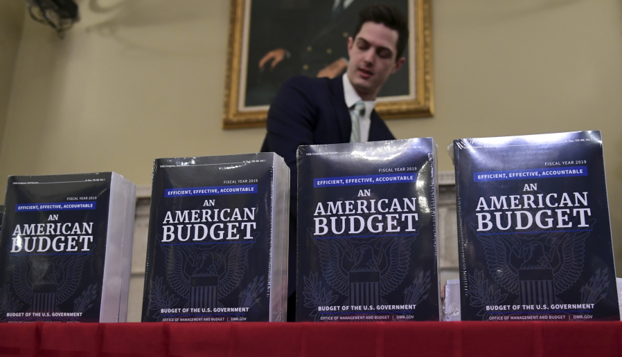 James Knable helps to unpack copies of the President’s FY19 Budget after it arrived at the House Budget Committee office on Capitol Hill in Washington, Monday.