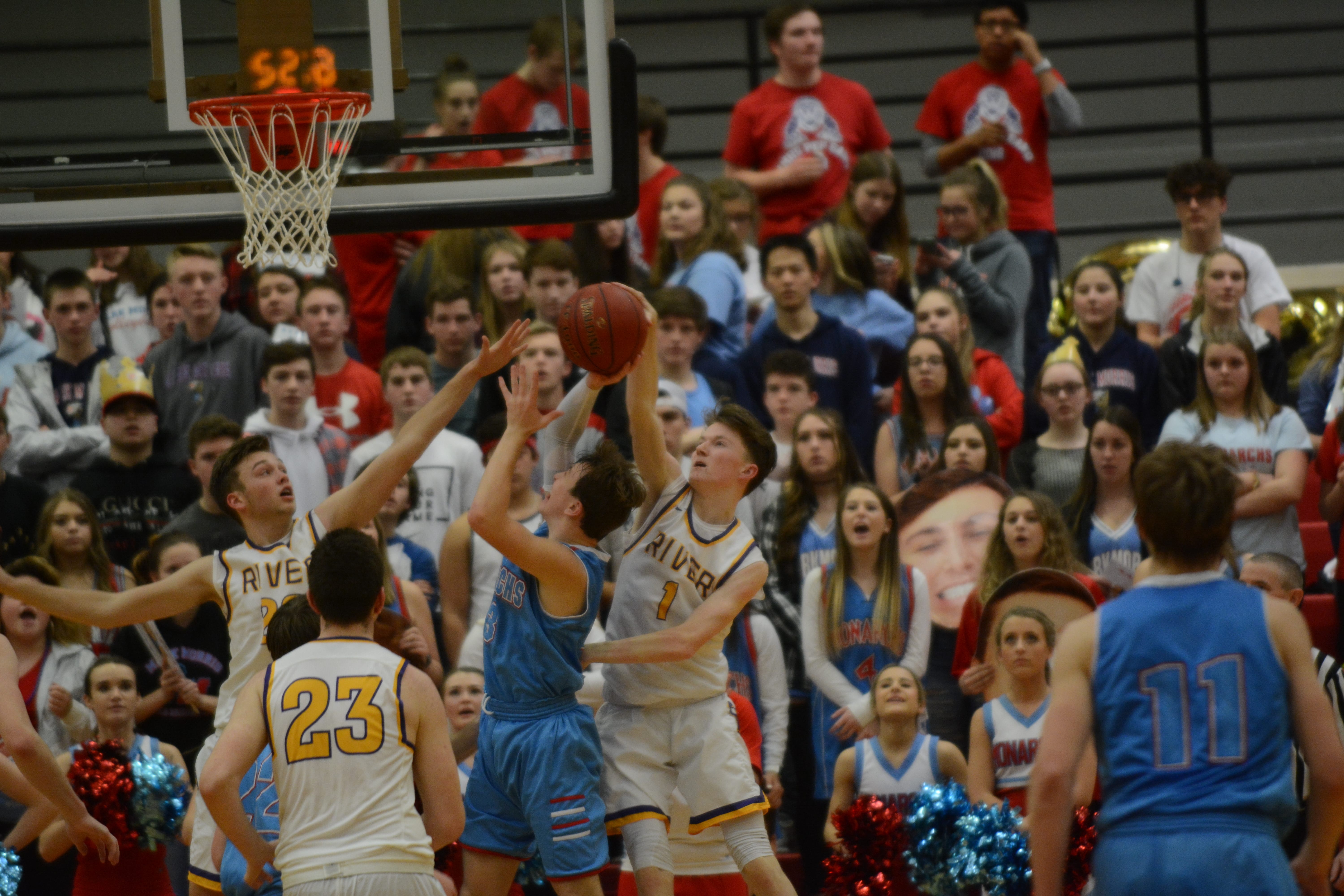 Columbia River guard Nate Snook contests a shot from a Mark Morris guard during a 50-49 loss to the Monarchs in the 2A district championship game at St. Martin's University on Friday, Feb.