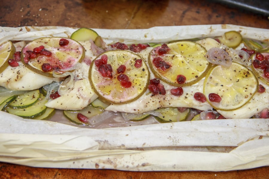 Cod With Pomegranate and Zucchini en Papillote (Melissa D’Arabian/AP)