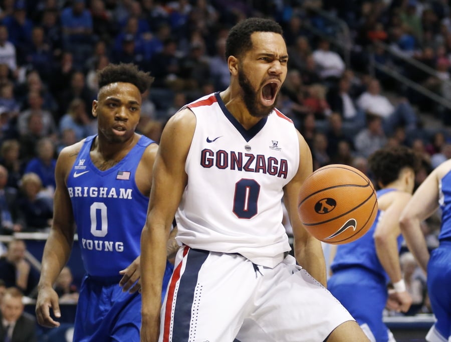 Gonzaga guard Silas Melson (0) reacts after dunking the ball while BYU guard Jahshire Hardnett (0) looks on in the first half of an NCAA college basketball game Saturday, Feb. 24, 2018, in Provo, Utah.