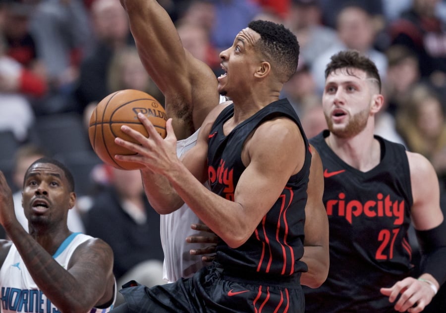 Portland Trail Blazers guard CJ McCollum, center, shoots against the Charlotte Hornets during the second half of an NBA basketball game in Portland, Ore., Thursday, Feb. 8, 2018.