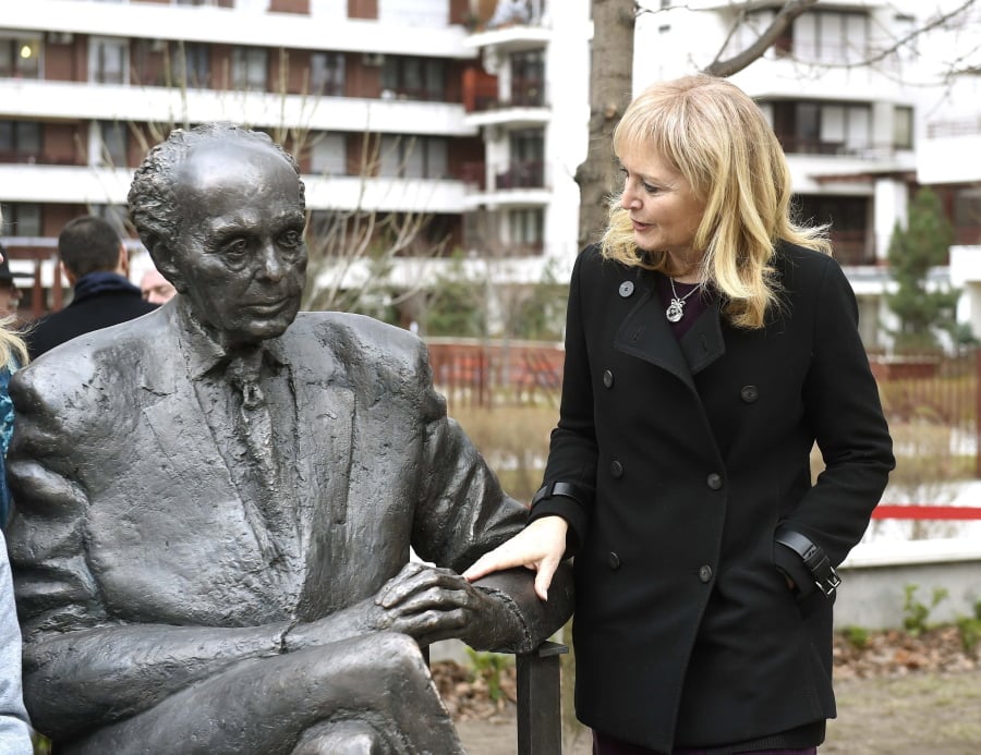 One of the daughters of the politician Katrina Lantos Swett touches the statue of her father, late US Congressman of Hungarian origin Tom Lantos during the unveiling ceremony near Lantos’ former school, Berzsenyi Daniel Secondary School, in Tom Lantos Walk in Budapest, Hungary, Thursday, Feb. 1, 2018.