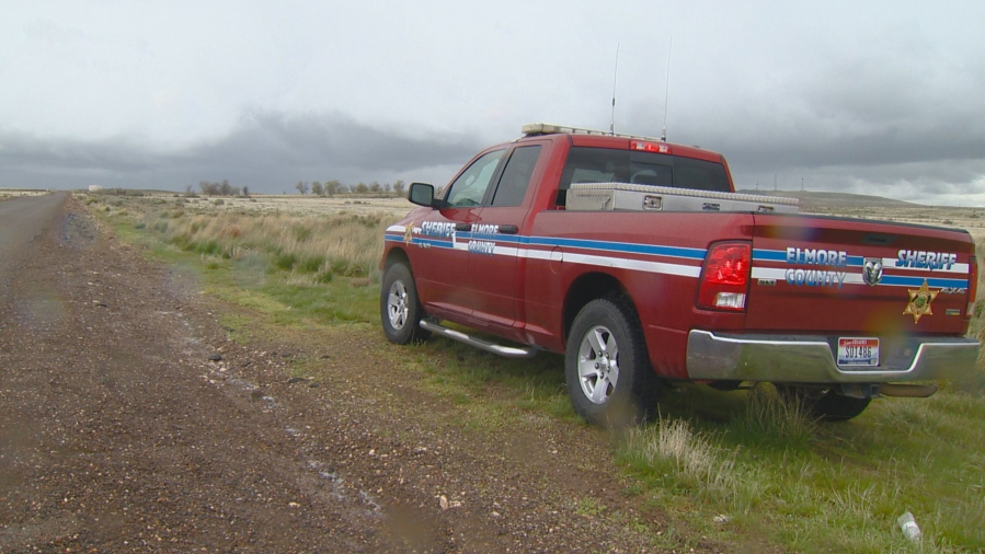 FILE - This April 15, 2017, file video image courtesy of KTVB-TV, shows an Elmore County Sheriff vehicle in the remote area where skeletal remains were found in a badger hole north of Mountain Home, Idaho. The U.S. government says it’s working with two Native American tribes to return the 500-year-old, well-preserved bones of a young adult and child found in a southwestern Idaho badger hole to one of the tribes.