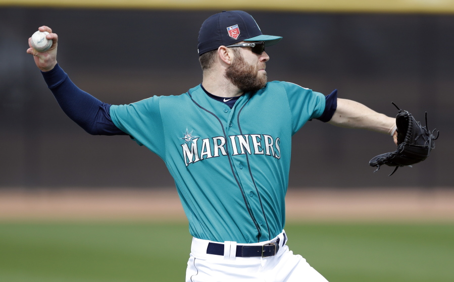 Seattle Mariners relief pitcher David Phelps throws in the outfield during a baseball spring training workout, Monday, Feb. 19, 2018, in Peoria, Ariz.