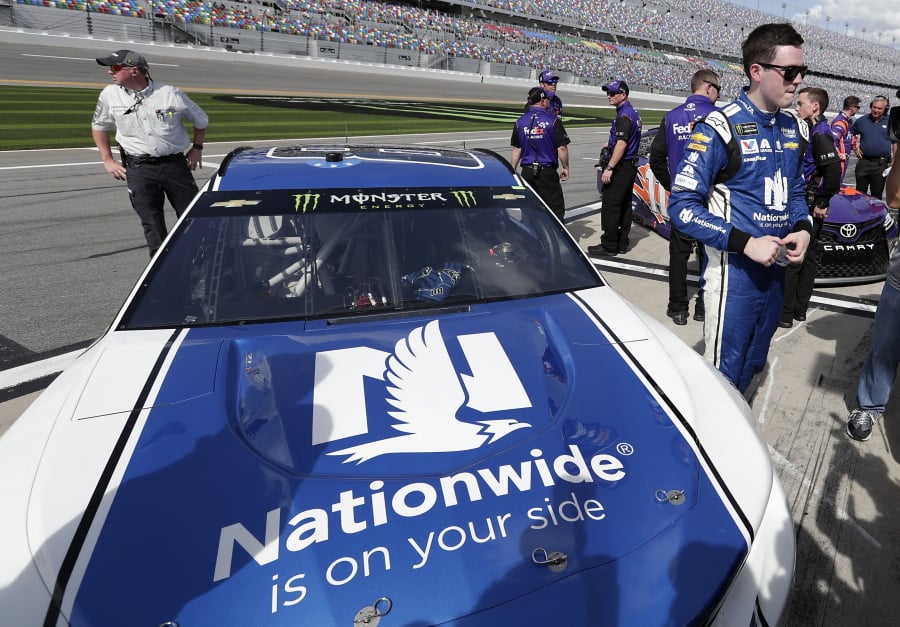 Alex Bowman, right, stands by his car on pit road after he won the pole position during qualifying for the NASCAR Daytona 500 auto race at Daytona International Speedway, Sunday, Feb. 11, 2018, in Daytona Beach, Fla.