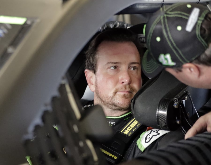 Kurt Busch, left, talks with a crew member before going out on the track during a NASCAR auto racing practice session at Daytona International Speedway, Saturday, Feb. 10, 2018, in Daytona Beach, Fla.