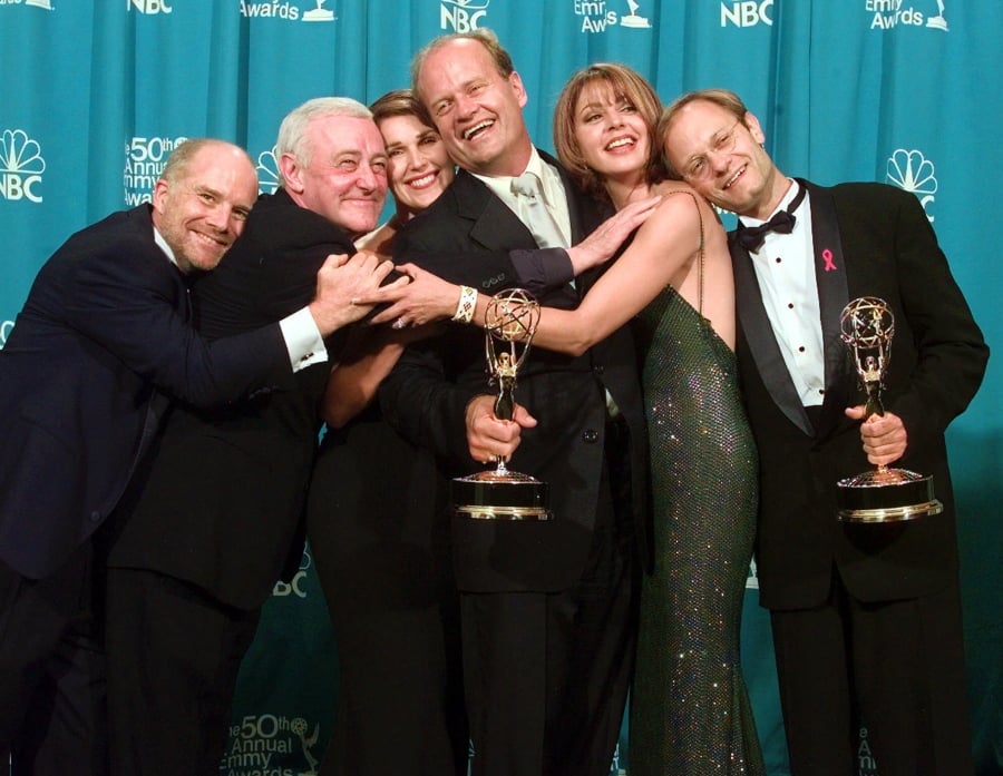 Cast members of “Frasier,” from left, Dan Butler, John Mahoney, Peri Gilpin, Kelsey Grammer, Jane Leeves and David Hyde Pierce, winners of the Emmy for Outstanding Comedy Series, pose backstage at the 50th annual Primetime Emmy Awards on Sept. 13, 1998, in Los Angeles.