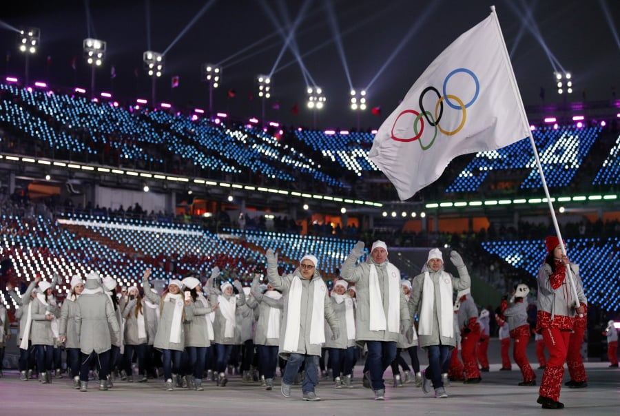 Athletes from Russia wave during the opening ceremony of the 2018 Winter Olympics in Pyeongchang, South Korea. Russia says the IOC has reinstated the country to the Olympic movement despite two failed doping tests by its athletes at the Pyeongchang Winter Olympics. In quotes carried by the TASS news agency, Russian Olympic Committee President Alexander Zhukov said a letter had been received earlier Wednesday, Feb. 28, 2018 from the IOC announcing the nation’s reinstatement. (AP Photo/Jae C.