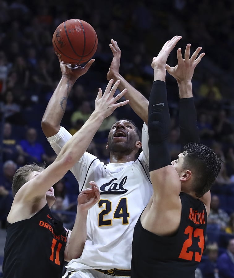 California’s Marcus Lee (24) shoots between Oregon State’s Zach Reichle, left, and Gligorije Rakocevic, right, in the first half of an NCAA college basketball game Saturday, Feb. 3, 2018, in Berkeley, Calif.