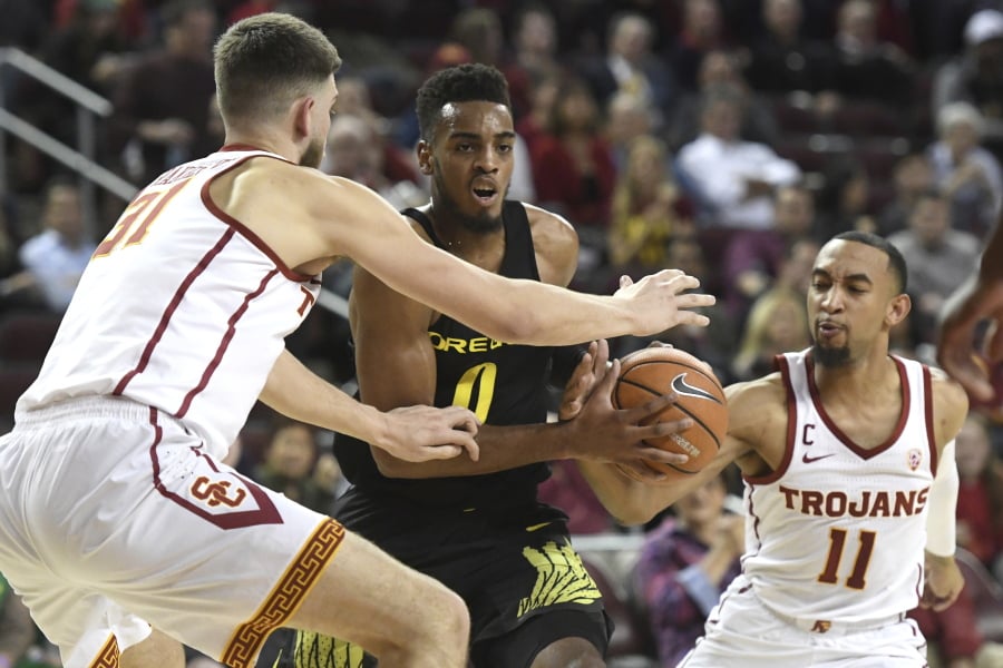 Oregon forward Troy Brown (0) drives against Southern California’s Nick Rakocevic, left, and Jordan McLaughlin (11) during the first half of an NCAA college basketball game, Thursday, Feb. 15, 2018, in Los Angeles.
