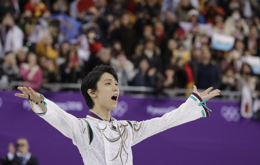 Yuzuru Hanyu of Japan gestures to the crowd as he prepares to stand on the podium after winning the gold medal in the men’s free figure skating final in the Gangneung Ice Arena at the 2018 Winter Olympics in Gangneung, South Korea, Saturday, Feb. 17, 2018. (AP Photo/David J.