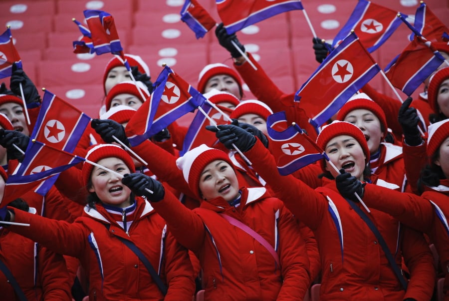Members of the North Korean delegation wave flags at the women’s slalom at Yongpyong alpine center at the 2018 Winter Olympics in Pyeongchang, South Korea. While in South Korea, the North Koreans wear the same uniforms, move together whenever possible and operate as a tightly knit team.