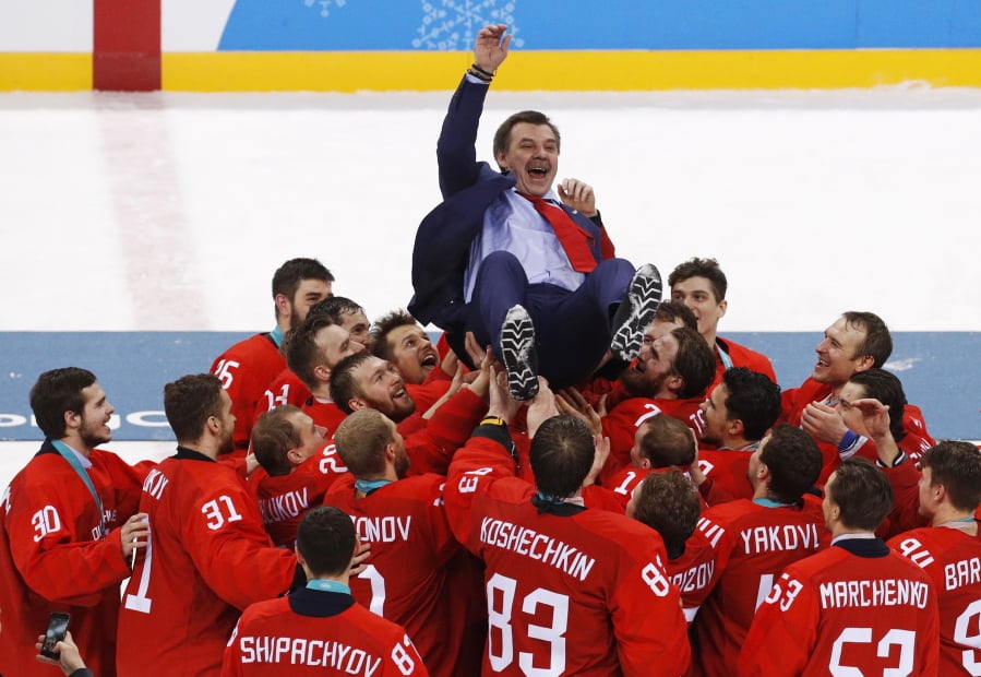Olympic athletes from Russia celebrate with their coach Oleg Znarok after winning the men’s gold medal hockey game against Germany, 4-3, in overtime at the 2018 Winter Olympics, Sunday, Feb. 25, 2018, in Gangneung, South Korea. (AP Photo/Jae C.