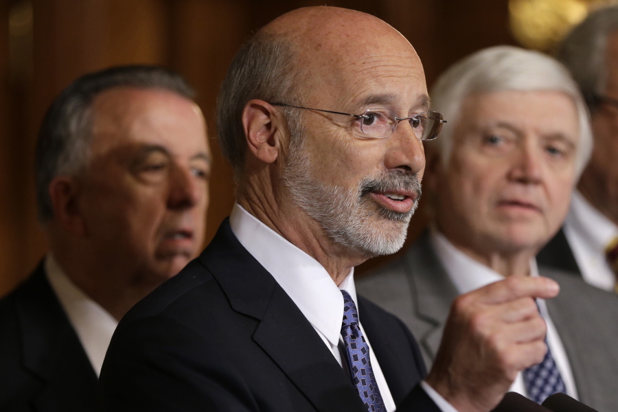 FILE - In this Oct. 7, 2015, file photo, Pennsylvania Gov. Tom Wolf, center, accompanied by state House Minority Leader Rep. Frank Dermody, right, D-Allegheny, and state Rep. Joe Markosek, left, D-Allegheny, discuss state budget negotiations at the state Capitol in Harrisburg, Pa. Pennsylvania’s high court issued a new congressional district map for the state’s 2018 elections on its self-imposed deadline Monday, Feb. 19, 2018, all but ensuring that Democratic prospects will improve in several seats and that Republican lawmakers challenge it in federal court. The map of Pennsylvania’s 18 congressional districts is to be in effect for the May 15 primary and substantially overhauls a congressional map widely viewed as among the nation’s most gerrymandered. The map was approved in a 4-3 decision.