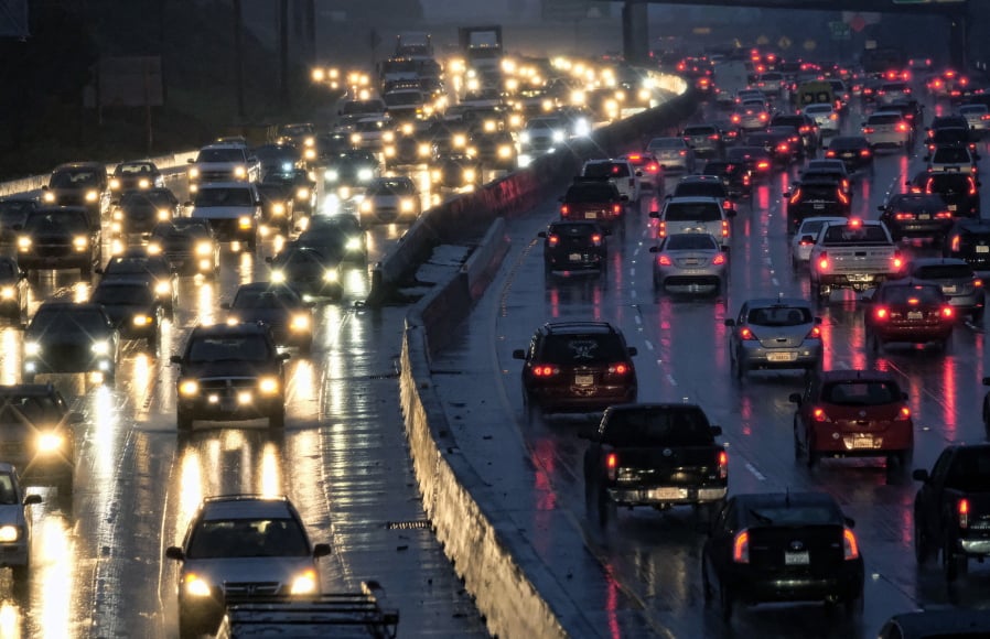 Early-morning traffic crawls on the Hollywood Freeway toward downtown Los Angeles in January. A survey by an urban planning group suggests that ride-hailing companies may be pulling riders off buses, subways and bicycles and putting them in cars.