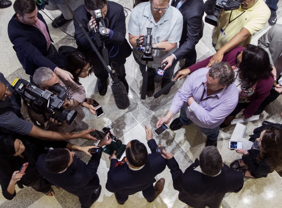 The press gather around Democrat Rep. Carlos Guillermo Smith for comments after the Republican leadership laid out their school safety proposal during a new conference at the Florida Capitol in Tallahassee, Fla., Friday, Feb 23, 2018.