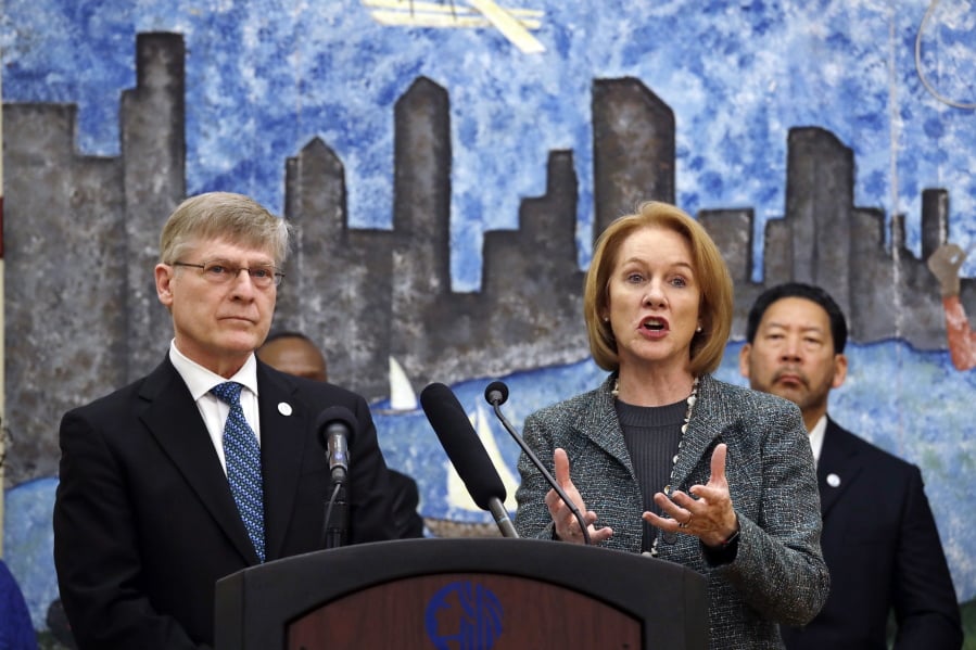 Seattle City Attorney Pete Holmes, left, looks on as Mayor Jenny Durkan speaks at a news conference announcing plans for the city to vacate misdemeanor marijuana possession convictions Thursday in Seattle.