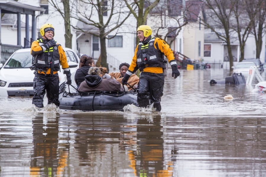 Emergency crews help evacuate residents, Wednesday, Feb. 21, 2018, in Elkhart, Ind. Crews are using boats to help northern Indiana residents amid flooding from melting snow and heavy rain moving across the Midwest.