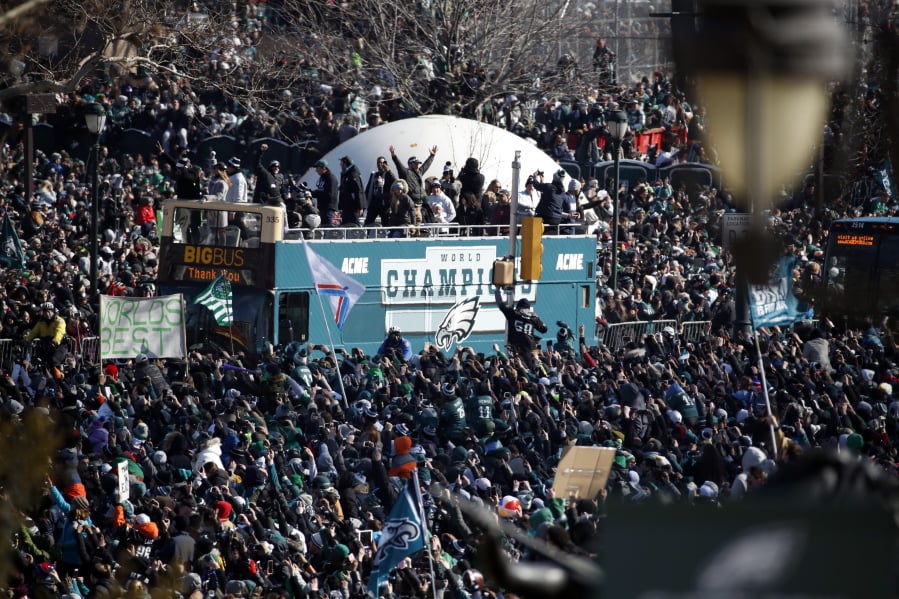 Fans cheer as a bus with team members arrives near the Philadelphia Museum of Art during a Super Bowl victory parade Thursday in Philadelphia.
