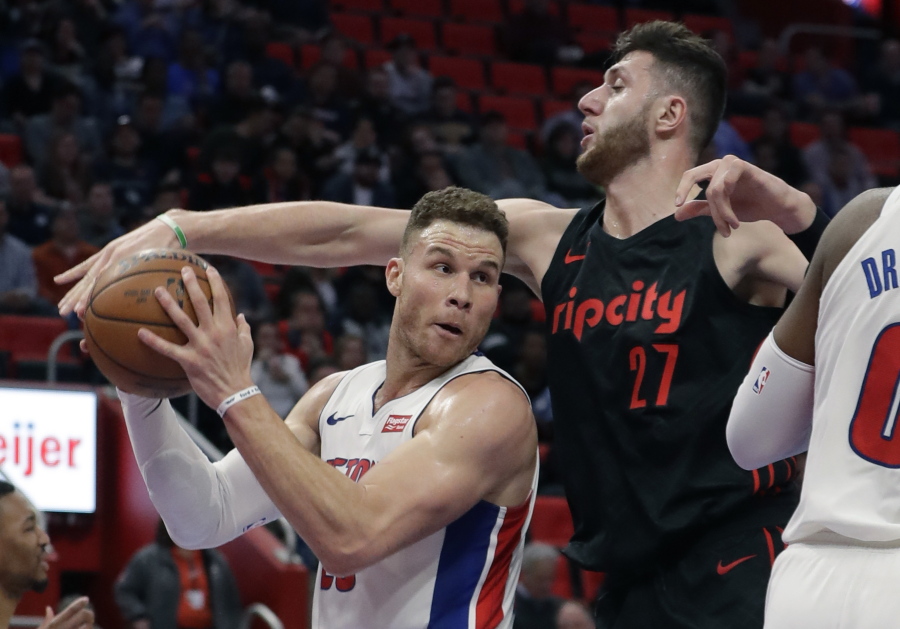 Portland Trail Blazers center Jusuf Nurkic (27) reaches in on Detroit Pistons forward Blake Griffin (23) during the first half of an NBA basketball game, Monday, Feb. 5, 2018, in Detroit.
