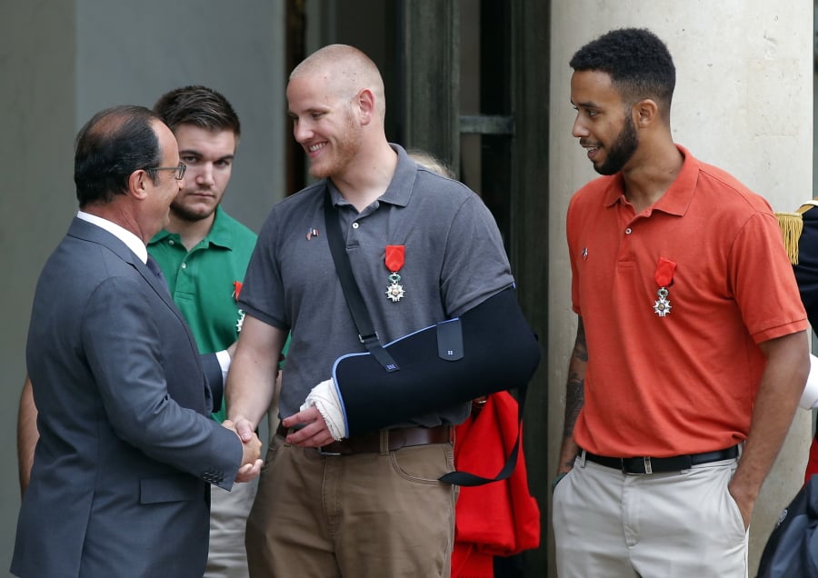 In this Aug. 24, 2015 file photo, French President Francois Hollande bids farewell to U.S. Airman Spencer Stone as U.S. National Guardsman Alek Skarlatos of Roseburg, Ore., second from left, and Anthony Sadler, a senior at Sacramento State University in California, right, look on after Hollande awarded them with the French Legion of Honor at the Elysee Palace in Paris. The wait is almost over to see Roseburg, Ore., hero Skarlatos on the big screen in "The 15:17 to Paris." Skarlatos plays himself in the film, as he and two friends reenact the day they saved hundreds of lives by thwarting a terrorist attack on a Paris-bound train.