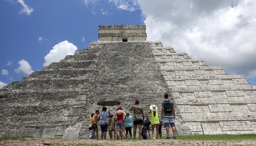 Tourists are dwarfed by El Castillo at the Chichen-Itza ruins July 22, 2016, in Yucatan, Mexico. While beach destinations remain popular for spring break, travel agents say customers are also demanding unique cultural experiences and active outdoorsy adventures.