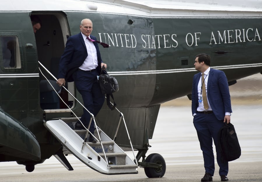 White House Chief of Staff John Kelly, left, walks off of Marine One as White House aide Johnny DeStefano, right, waits, as they arrive at Andrews Air Force Base in Md., with President Donald Trump, Friday, Feb. 16, 2018. Trump is heading to Florida to spend the weekend at his Mar-a-Lago estate.