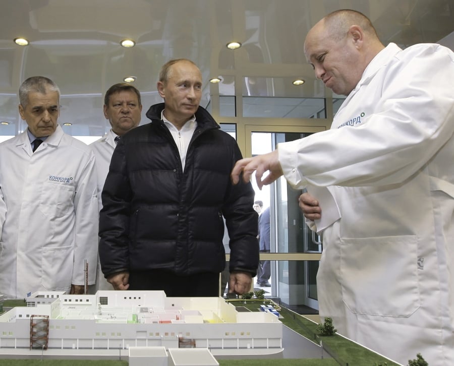 Yevgeny Prigozhin, right, shows Russian President Vladimir Putin, second from right, around his factory outside St. Petersburg, Russia, in 2010.