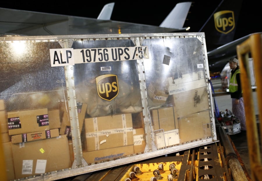A UPS airplane is unloaded at the company’s Worldport hub in Louisville, Ky.
