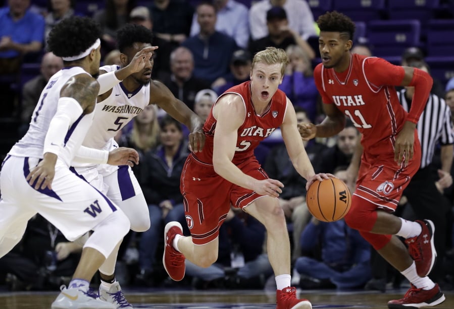 Utah’s Parker Van Dyke, second right, races up the court past Chris Seeley (11) and Washington’s Jaylen Nowell (5) and David Crisp during the first half of an NCAA college basketball game Thursday, Feb. 15, 2018, in Seattle.