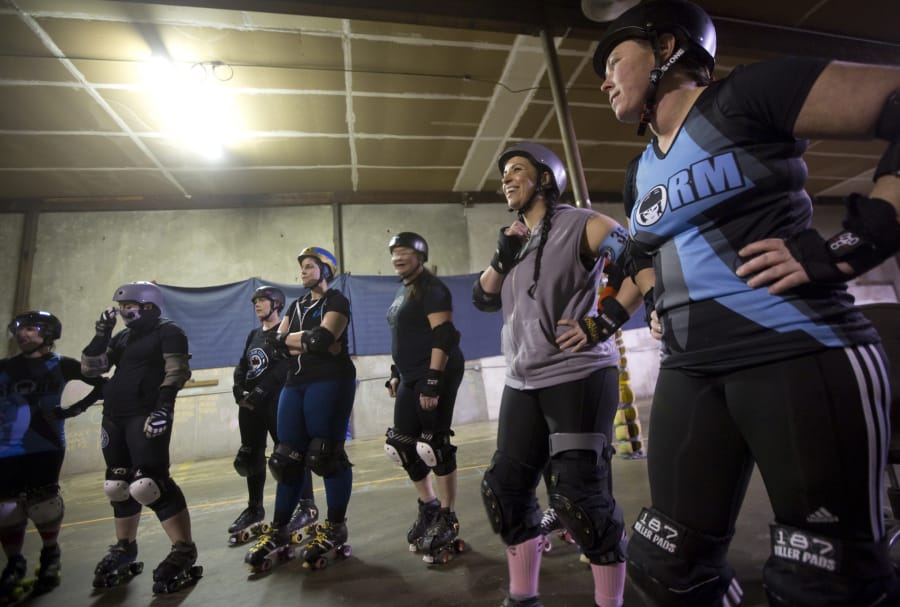 The Storm City Roller Girls discuss strategy before a practice session in Hazel Dell in 2017. The team is hosting a daylong tournament Saturday at the Clark County Event Center at the Fairgrounds. Five out-of-town teams will be participating.