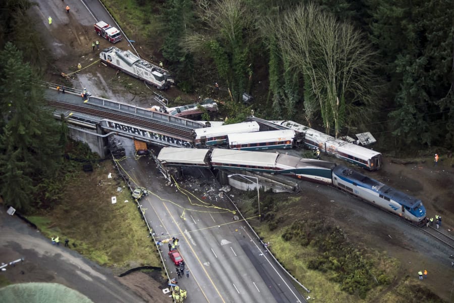 Cars from an Amtrak train that derailed are spilled onto Interstate 5 on Dec. 18 in DuPont.