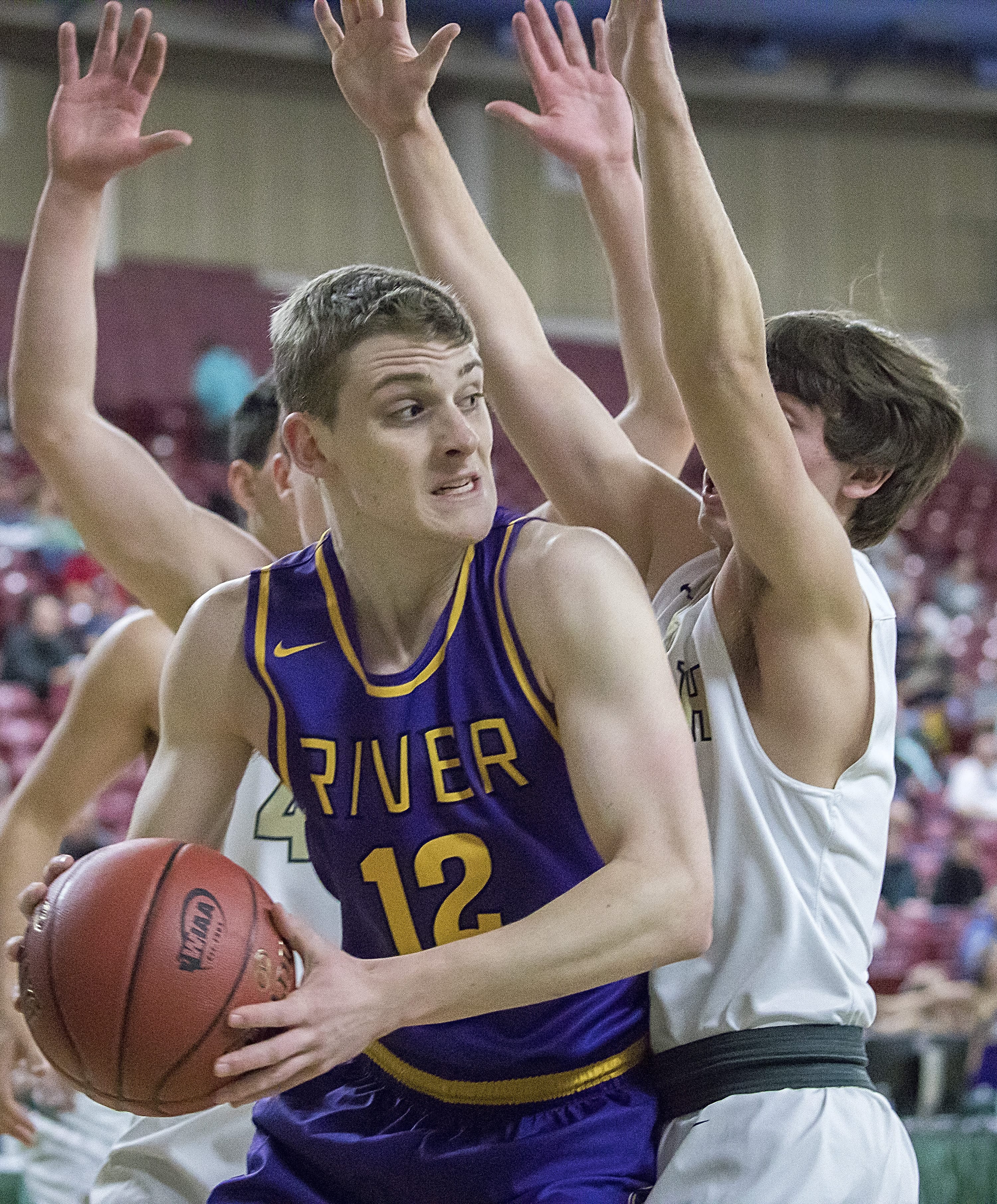 Columbia River’s Jacob Hjort (12) moves to pass around Selah’s Calvin Herting (3) in the WIAA 2A boys state basketball tournament on Saturday, Mar. 3, 2018, at the Yakima Valley SunDome. The Columbia River Chieftains took 6th place in state after losing to the The Selah Vikings 58-51.