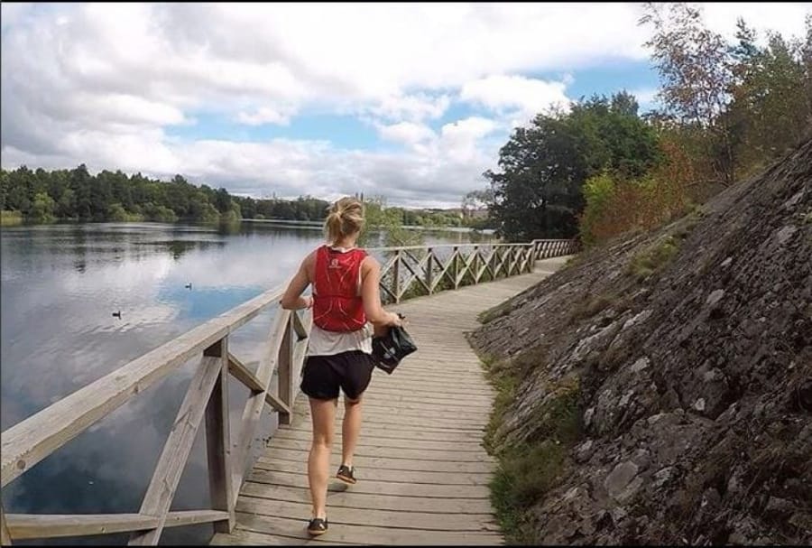 Maja Tesch carries a bag containing litter while plogging in Stockholm.