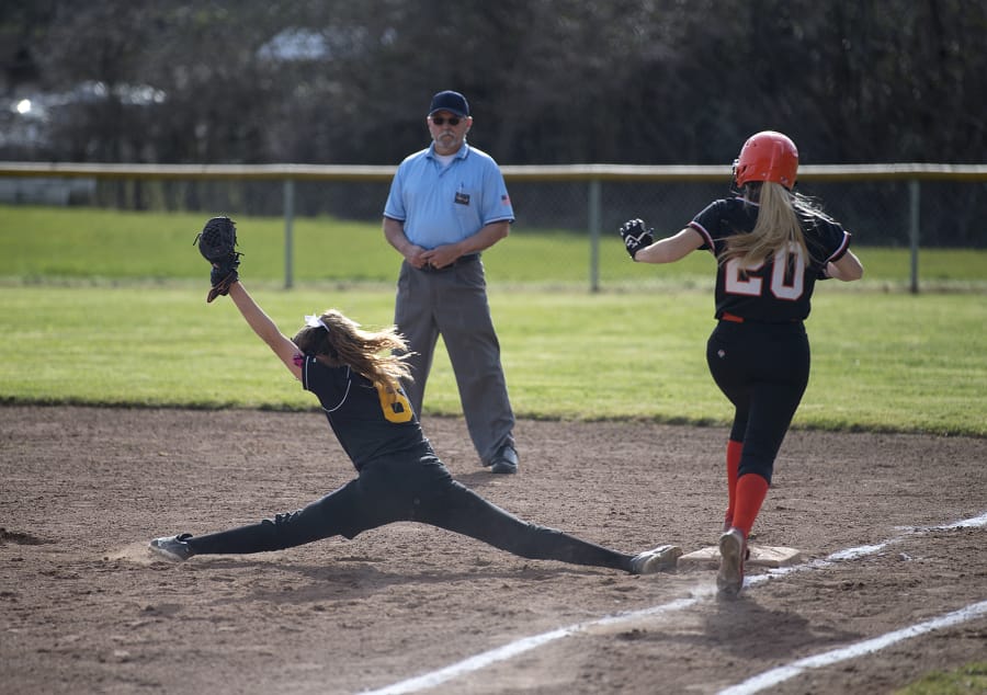Hudson’s Bay’s Regan Kelly (6) stretches out to make the catch at first base against Washougal at Washougal High School on Monday afternoon. Washougal won 15-14.