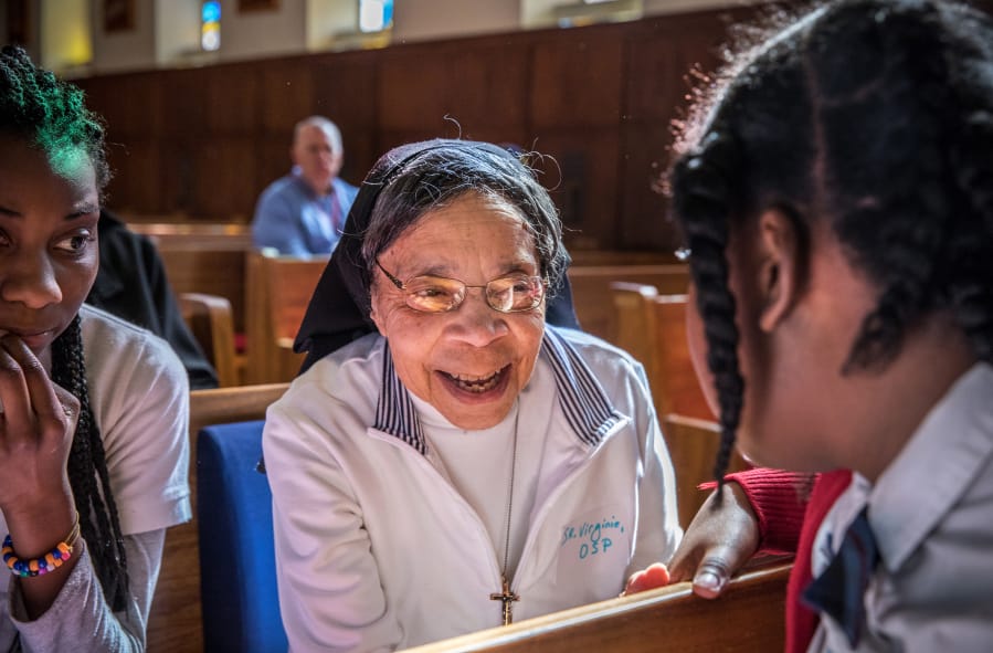 Sister Virginie Fish talks with students from St. Francis International School in Silver Spring, Md., after Mass at the Oblate Sisters of Providence convent in Baltimore.