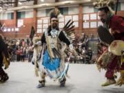 Louis Kameroff of Vancouver and of the Yupik and Modoc tribes, center, and Corey Nasewytewa of Beaverton, Ore., and of the Hopi and Gila River Pima tribes, right, dance during the grand entry parade Saturday at the annual Traditional Pow Wow hosted by the Native American Parent Association of Southwest Washington. Hundreds of people attended to watch dozens of dancers and drummers perform.